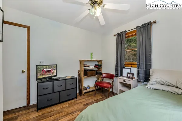 a view of a house with a yard and large tree