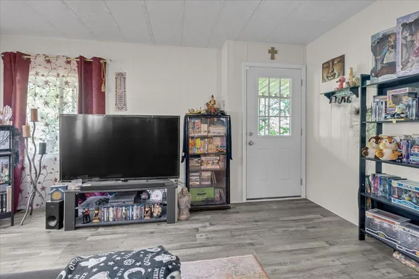 a bedroom with a bed couch and a window