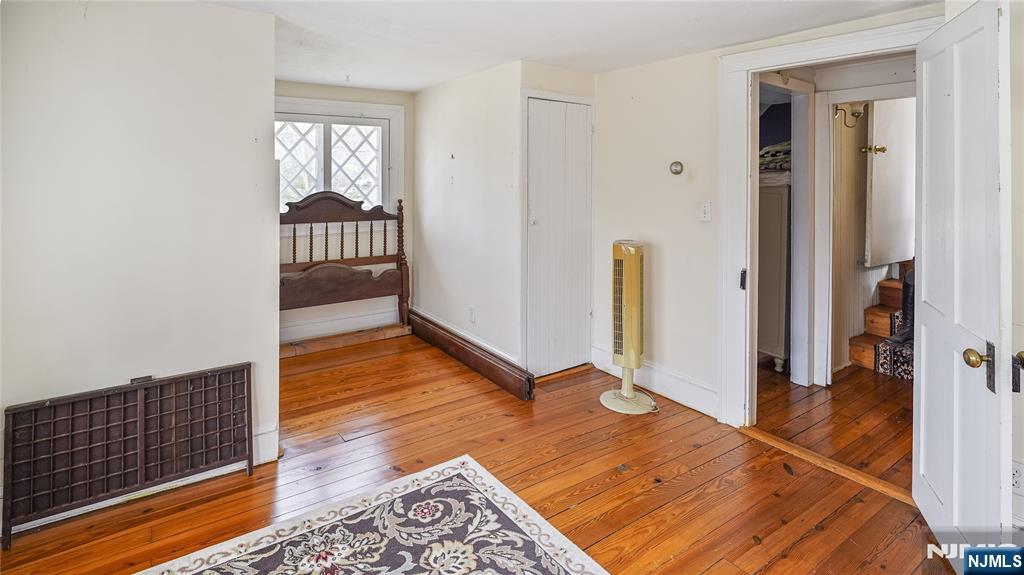 695 Ramapo Valley Road Oakland, NJ 07436 - Photo 35 of 42 a view of a room with wooden floor and stairs