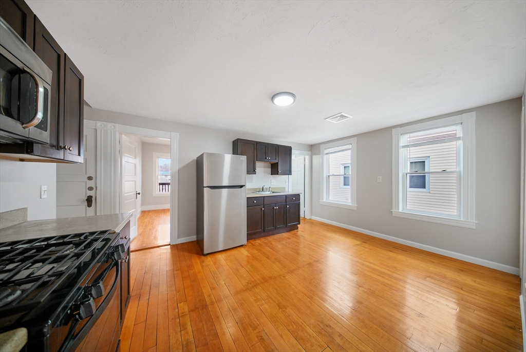 16 Bellevue Avenue, Unit 4 Brockton, MA 02302 - Photo 1 of 10 a kitchen with granite countertop a stove and a refrigerator
