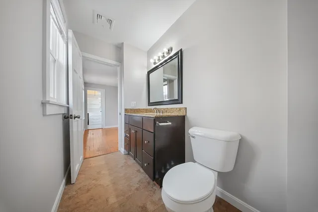 a white toilet sitting next to a bathroom sink