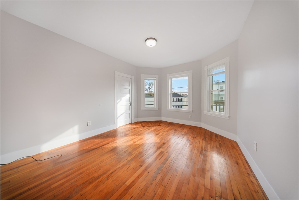 16 Bellevue Avenue, Unit 4 Brockton, MA 02302 - Photo 5 of 10 wooden floor in an empty room with a window