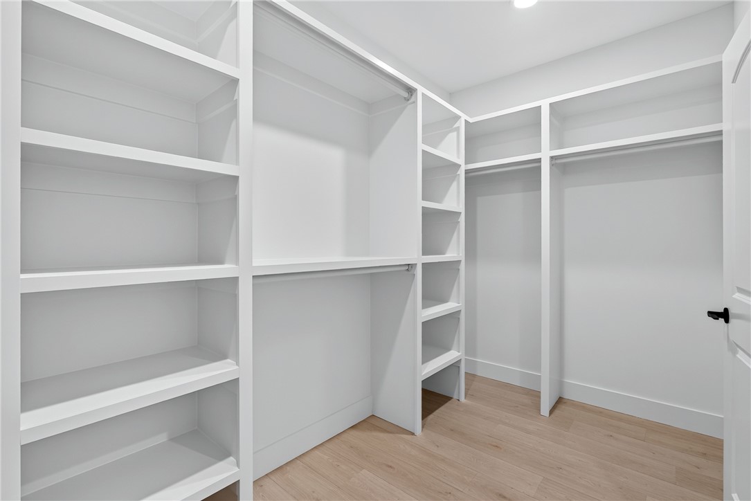 414 Blume Road Anderson, SC 29625 - Photo 37 of 50 Custom built-in shelving and hanging rods maximize storage space over light hardwood flooring.