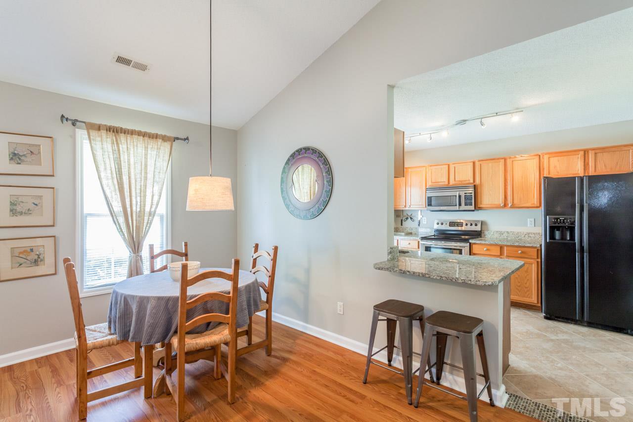 6007 Newhall Road Durham, NC 27713 - Photo 11 of 25 a view of a dining room with furniture and a large window