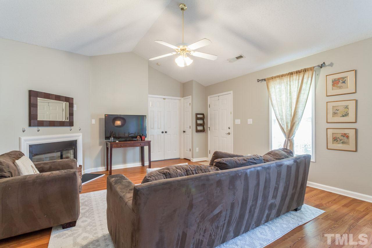 6007 Newhall Road Durham, NC 27713 - Photo 5 of 25 a living room with furniture and a fireplace