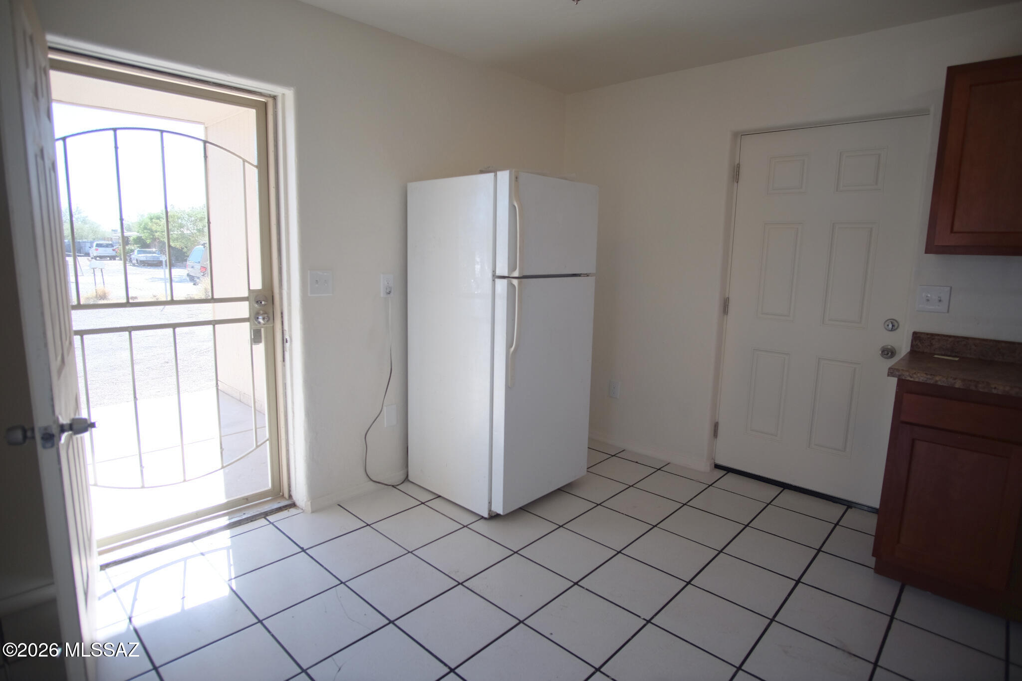 345 East Delta Road Tucson, AZ 85706 - Photo 9 of 45 a view of empty room with window and refrigerator