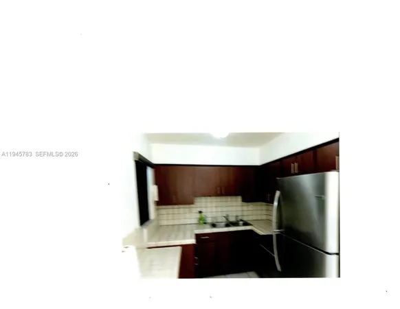 a kitchen with a sink and a refrigerator