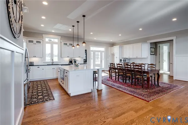 a view of a hallway with wooden floor and a living room