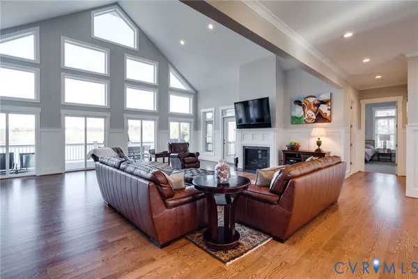 a view of a room with furniture and wooden floor