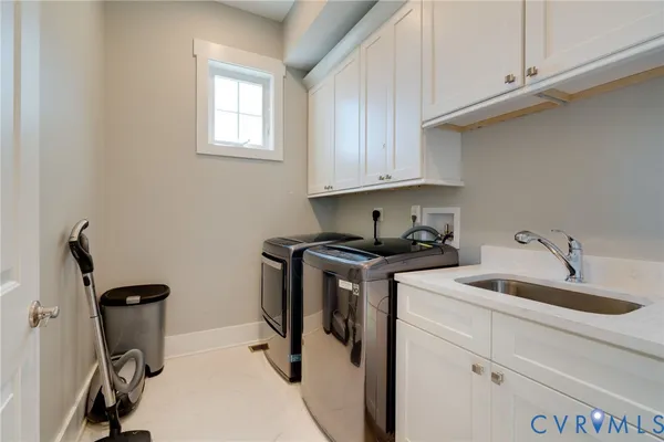 a spacious bedroom with a bed and a chandelier