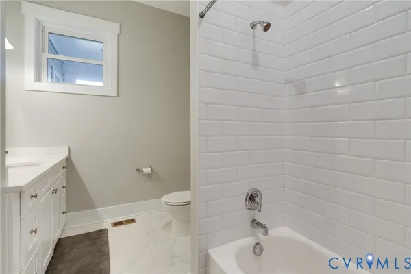 a spacious bedroom with a bed and a ceiling fan