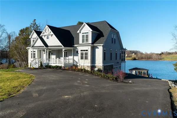 a bedroom with a bed a table and a potted plant