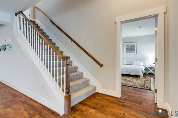 a view of a roof deck with couches and wooden floor