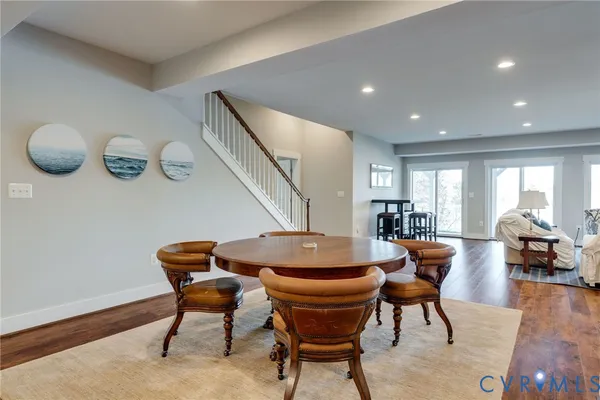 a view of swimming pool with lawn chairs and large trees