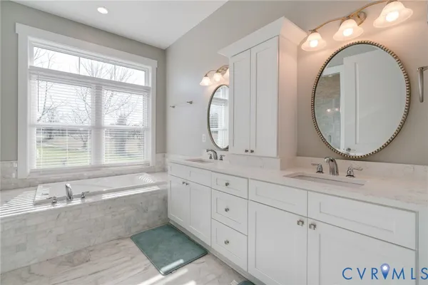 a large kitchen with stainless steel appliances a stove a sink dishwasher and a dining table with the living room view