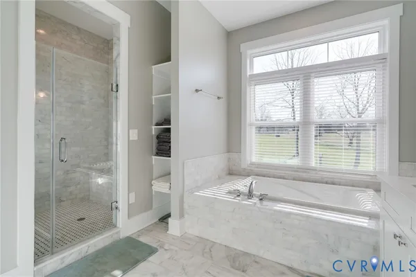 a living room with furniture a flat screen tv and a large window