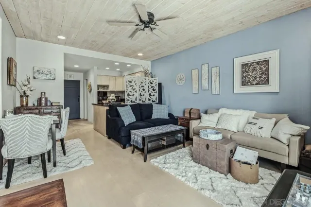 a living room with furniture tv and large window