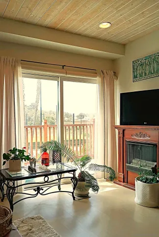a view of balcony with couch and chairs
