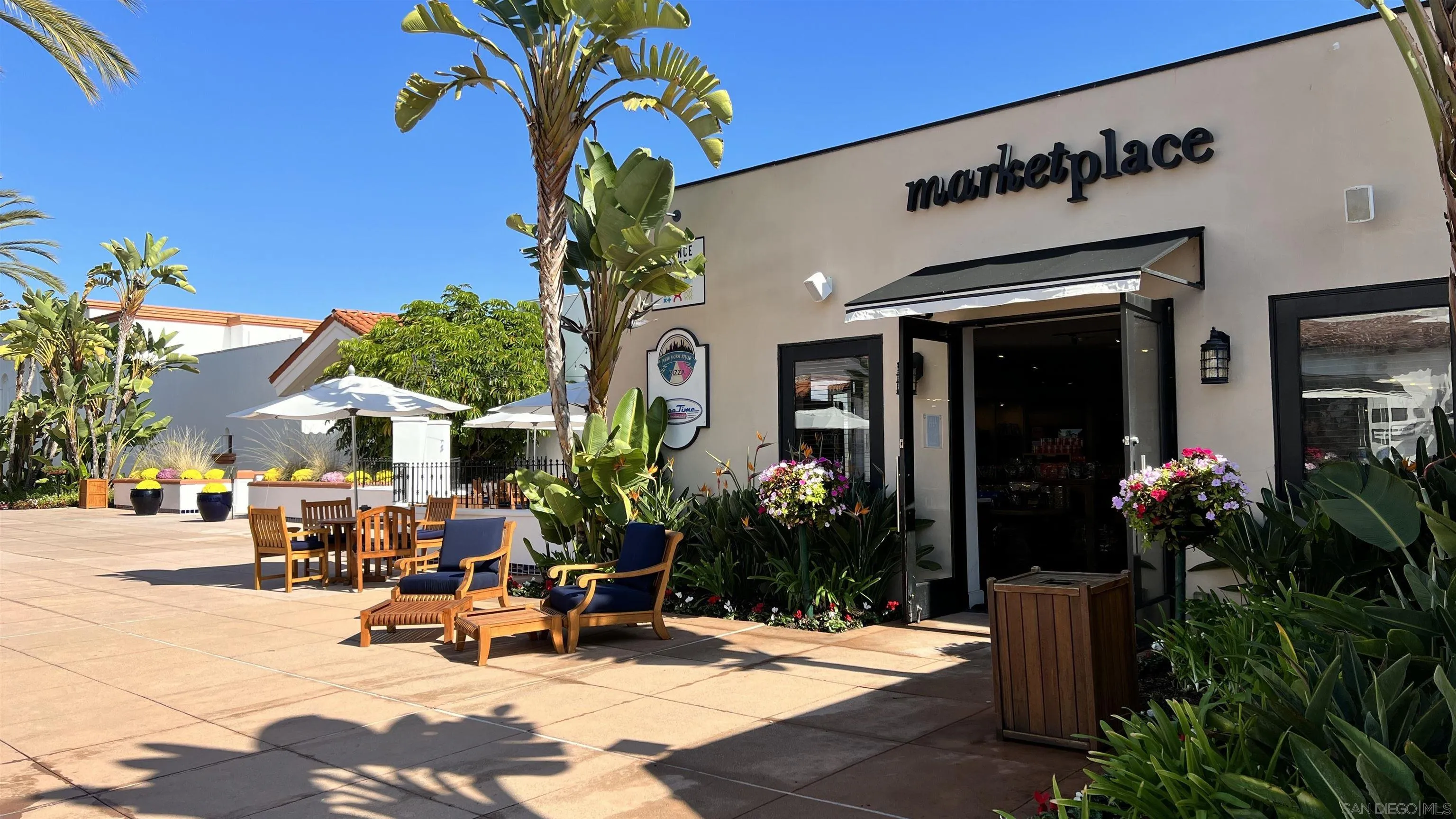 2003 Costa Del Mar Road, Unit 692 Carlsbad, CA 92009 - Photo 37 of 42 a view of the patio with dining table and chairs potted plants