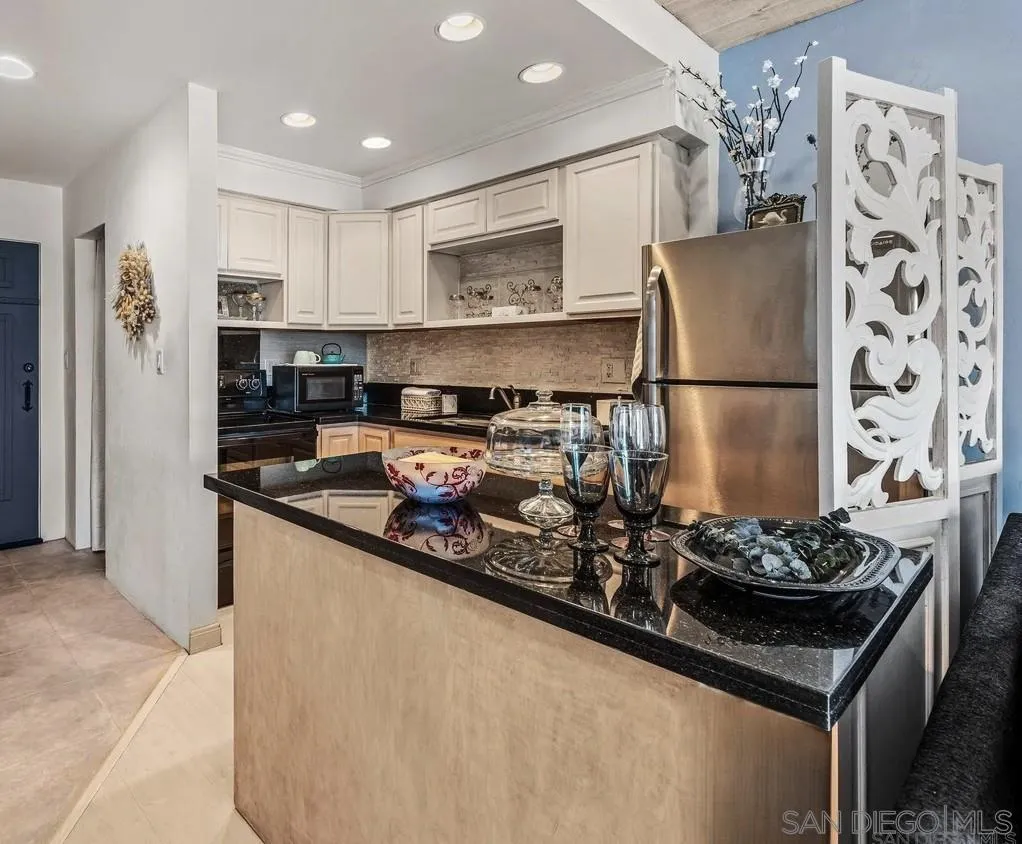 2003 Costa Del Mar Road, Unit 692 Carlsbad, CA 92009 - Photo 8 of 42 a kitchen with stainless steel appliances granite countertop a sink stove and refrigerator