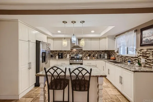 a kitchen with a refrigerator and cabinets