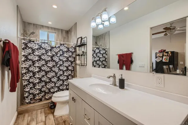 a bathroom with a sink toilet and shower