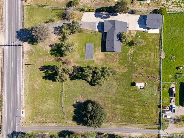an aerial view of a residential houses with outdoor space