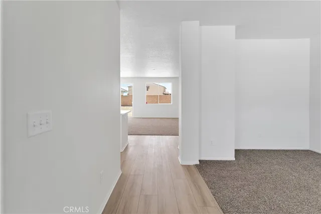 a view of a room with wooden floor and a window