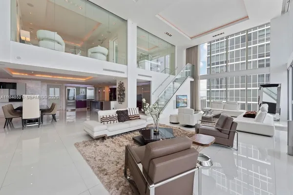 a view of living room with furniture and floor to ceiling windows