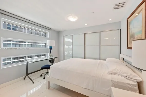 a bedroom with a bed and a dresser