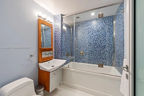 a bathroom with a bathtub toilet and shower