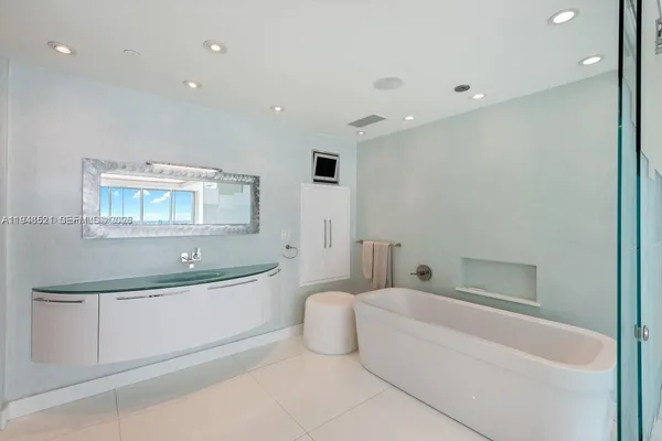 a bathroom with a bathtub and a sink