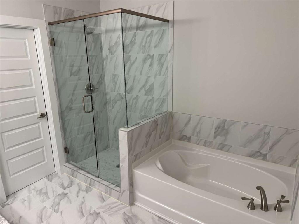 2530 Harbor Ridge Gainesville, GA 30507 - Photo 30 of 44 a bathroom with a bathtub and a shower