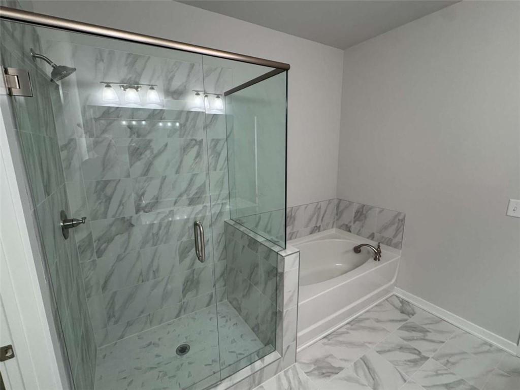 2530 Harbor Ridge Gainesville, GA 30507 - Photo 33 of 44 a bathroom with a shower and a bath tub
