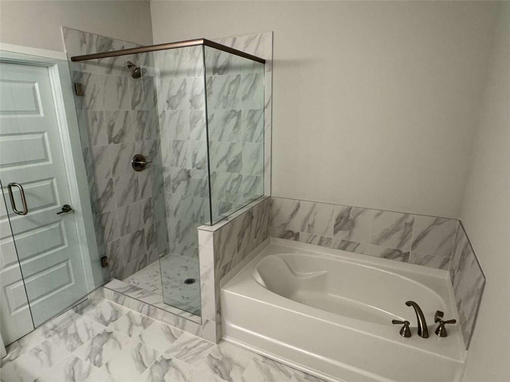 2530 Harbor Ridge Gainesville, GA 30507 - Photo 36 of 44 a bathroom with a bathtub and shower