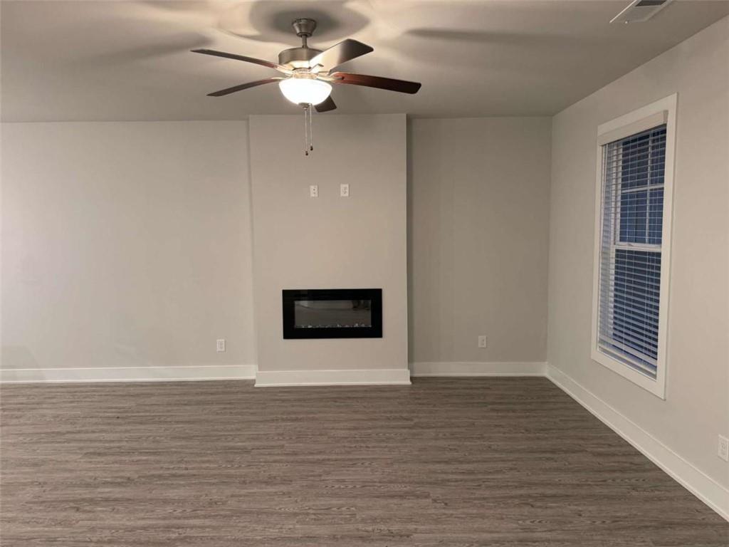2530 Harbor Ridge Gainesville, GA 30507 - Photo 4 of 44 a view of an empty room with wooden floor and a ceiling fan