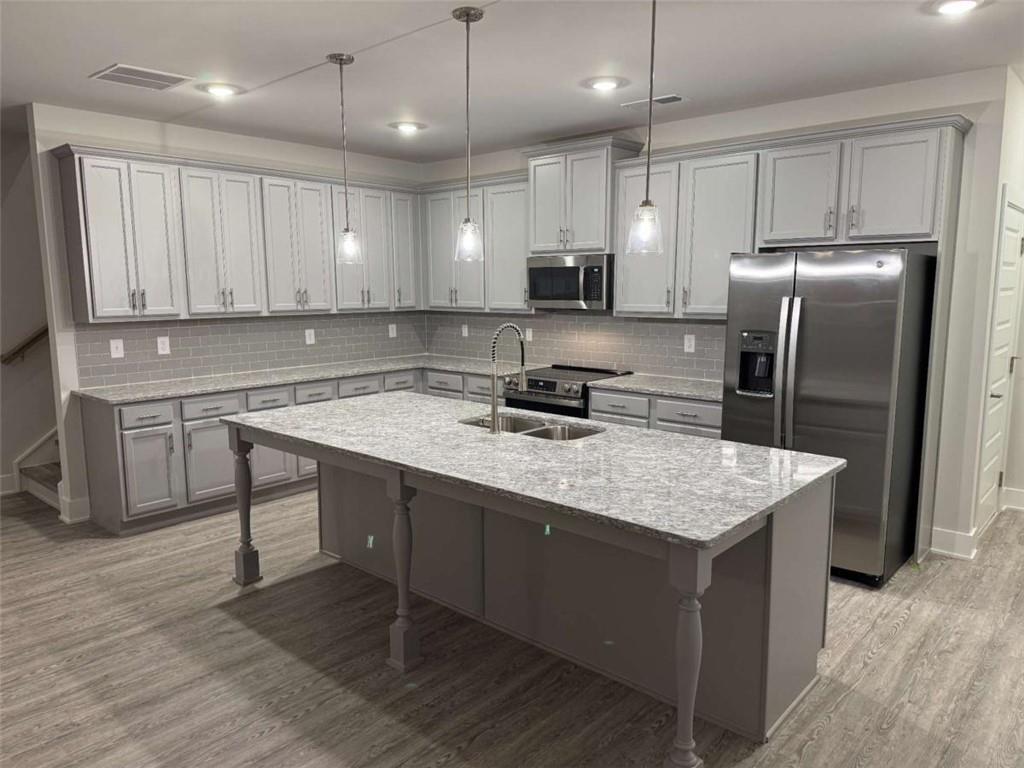 2530 Harbor Ridge Gainesville, GA 30507 - Photo 8 of 44 a kitchen with kitchen island granite countertop a sink refrigerator and microwave