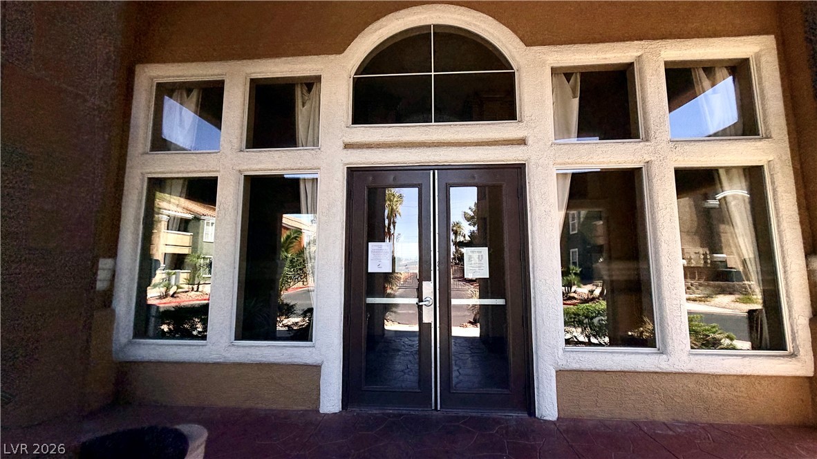 8101 West Flamingo Road, Unit 1082 Las Vegas, NV 89147 - Photo 16 of 23 A grand arched entry with double doors welcomes residents and guests into this attractive building.