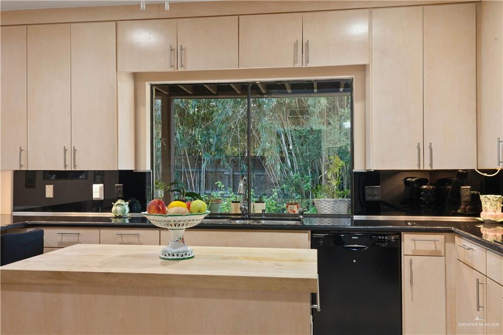 1113 Xanthisma Avenue McAllen, TX 78504 - Photo 12 of 30 Kitchen featuring light brown cabinetry, wood counters, black dishwasher, and tasteful backsplash
