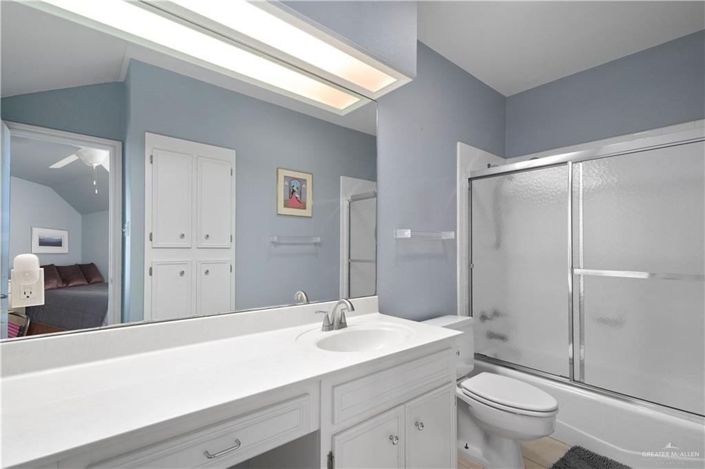 1113 Xanthisma Avenue McAllen, TX 78504 - Photo 18 of 30 Ensuite bathroom featuring vanity, shower / bath combination with glass door, and lofted ceiling