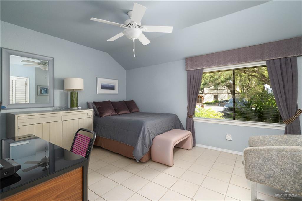 1113 Xanthisma Avenue McAllen, TX 78504 - Photo 19 of 30 Bedroom featuring vaulted ceiling, light tile patterned flooring, and a ceiling fan