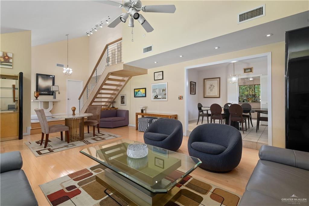 1113 Xanthisma Avenue McAllen, TX 78504 - Photo 5 of 30 Living area with a ceiling fan, a chandelier, light wood-style flooring, recessed lighting, and high vaulted ceiling