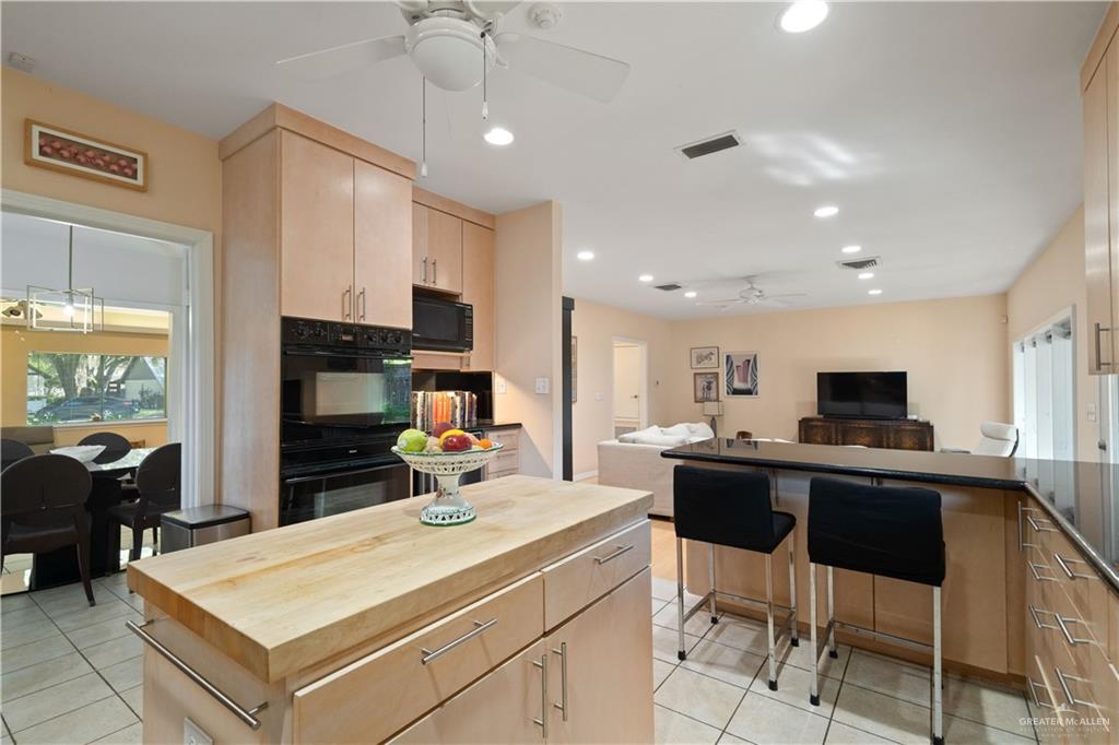 1113 Xanthisma Avenue McAllen, TX 78504 - Photo 30 of 30 Kitchen featuring light brown cabinets, plenty of natural light, a ceiling fan, open floor plan, and recessed lighting