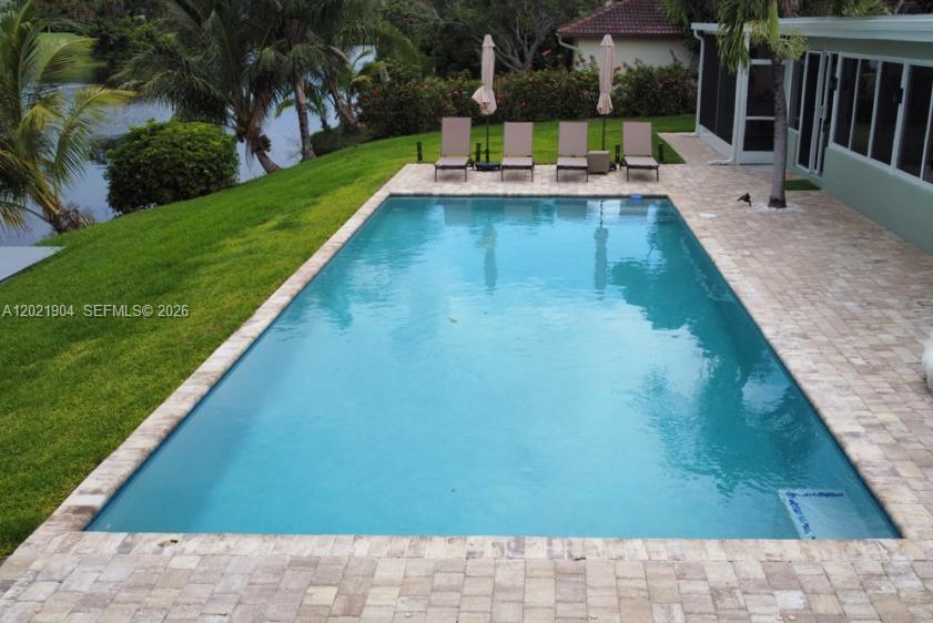3324 Lakeview Boulevard Delray Beach, FL 33445 - Photo 31 of 36 a view of a swimming pool with a patio