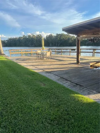 a view of a swimming pool with an outdoor seating yard and mountain view in back