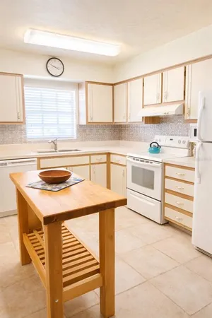 a kitchen with stainless steel appliances granite countertop a sink and a stove