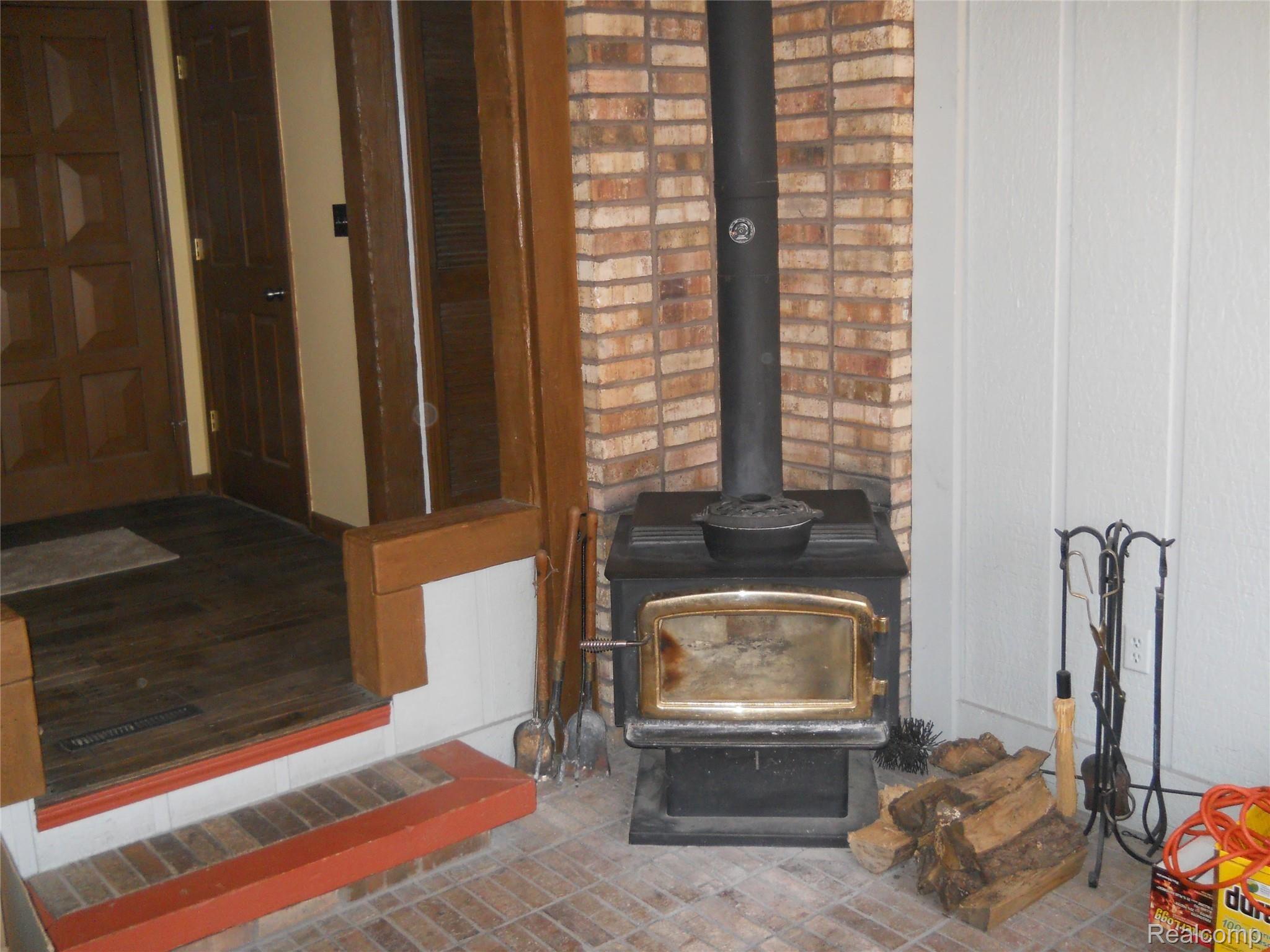 5929 Layton Road Fowlerville, MI 48836 - Photo 11 of 24 woodburner in 4 season room
