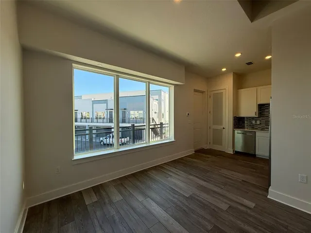 a view of wooden floor and a kitchen
