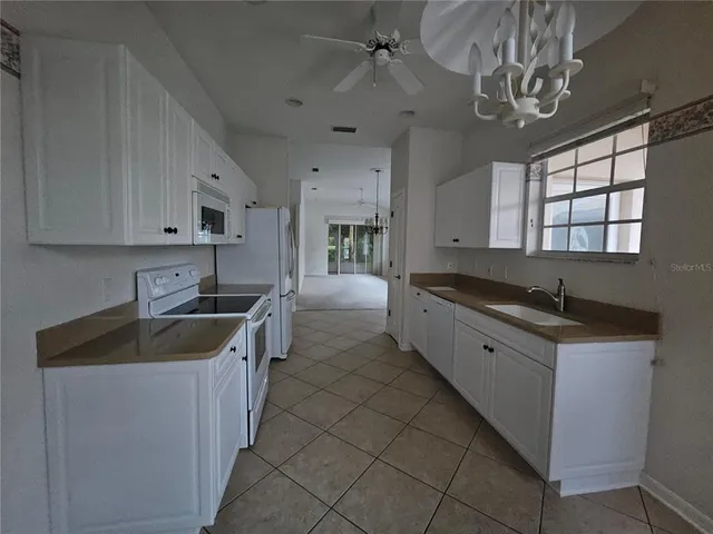 a kitchen with stainless steel appliances granite countertop a sink and a stove