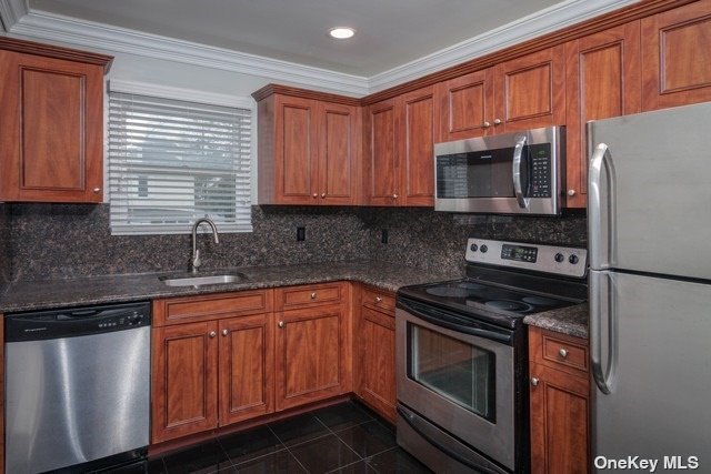 a kitchen with stainless steel appliances granite countertop wooden cabinets a stove a sink and dishwasher